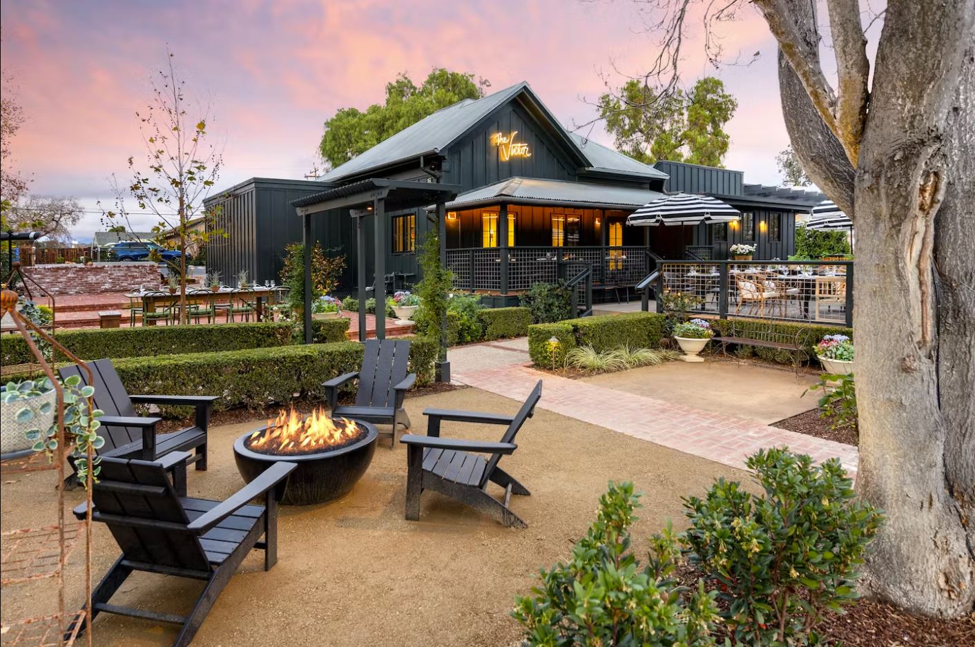 Photo of exterior of the Victor website with fire pit and lounge chairs